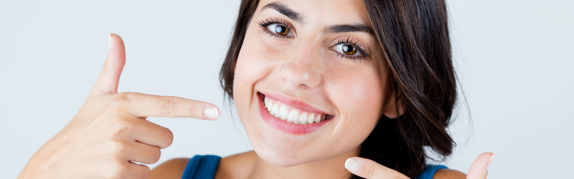 Woman pointing at her teeth