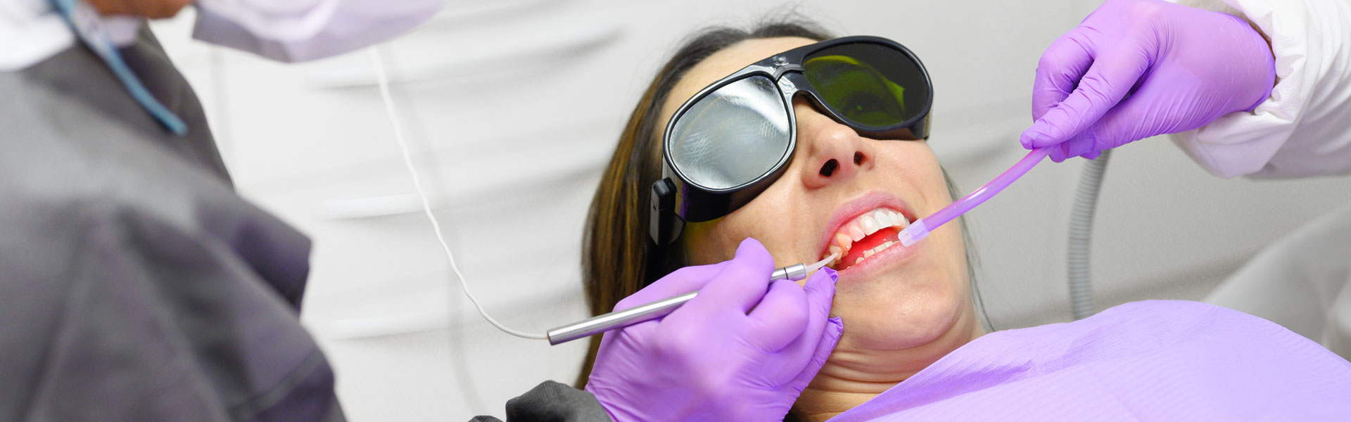 Dentist doing laser gum treatments